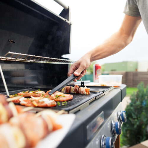 Hand,Of,Young,Man,Grilling,Some,Meat,And,Vegetable-meat,Skewers